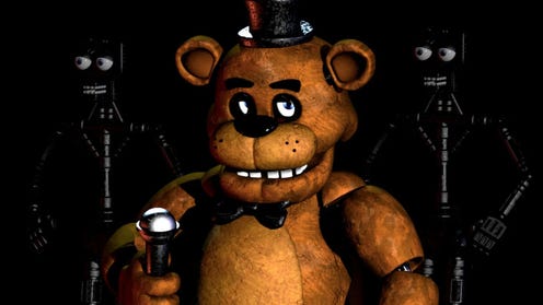 Freddy Fazbear stands in front of animatronic endoskeletons