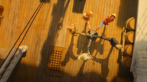 Still image from One Piece, featuring core cast with their foot on a barrel